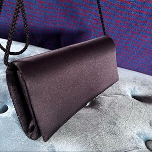 Black satin clutch purse Snap close long cord handle over shoulder or tuck in